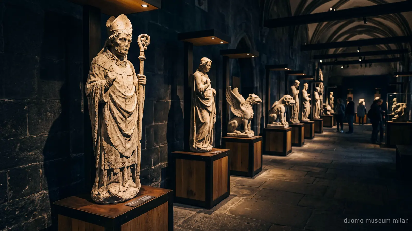 Original Gothic statues and gargoyles from Milan Cathedral displayed at eye level in the Duomo Museum
